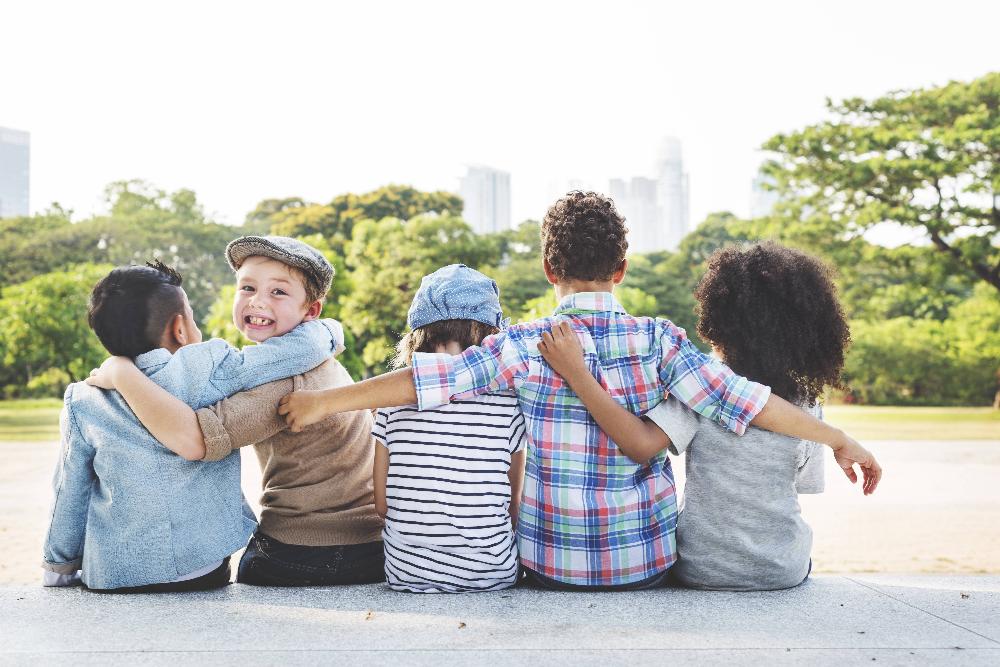 group of children hugging outside | children's dentist lakeville