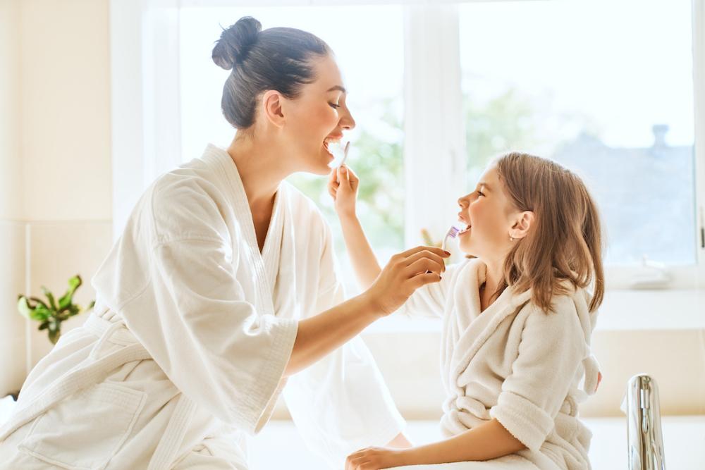 mother and daughter brushing teeth | dental cleanings lakeville mn
